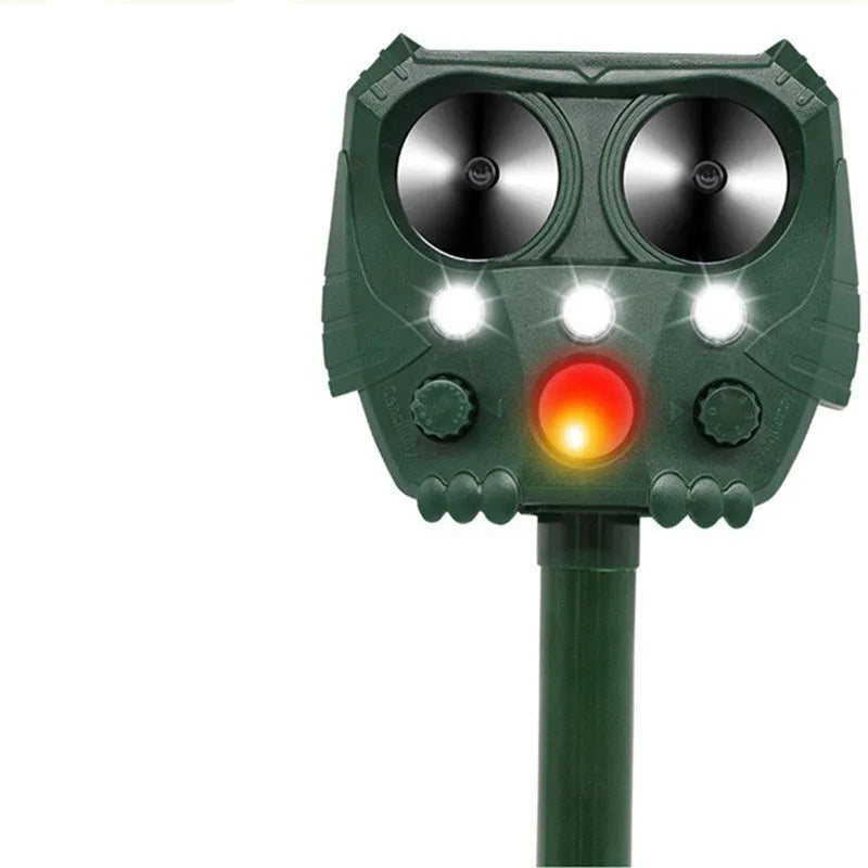 Green solar-powered ultrasonic animal repeller with dimensions 12x13x5cm