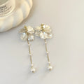 Women's acrylic shell pearl tassel earrings with multiple clip options showing 8.8cm length