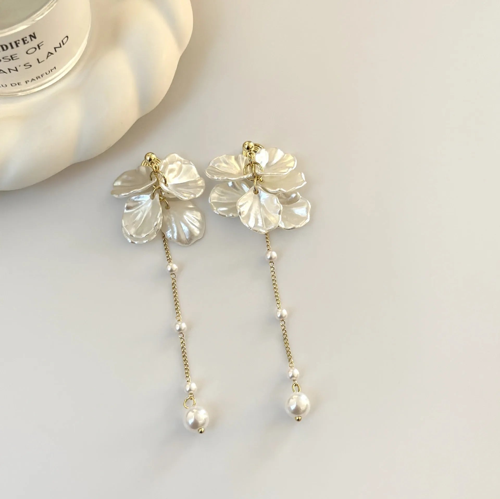 Women's acrylic shell pearl tassel earrings with multiple clip options showing 8.8cm length