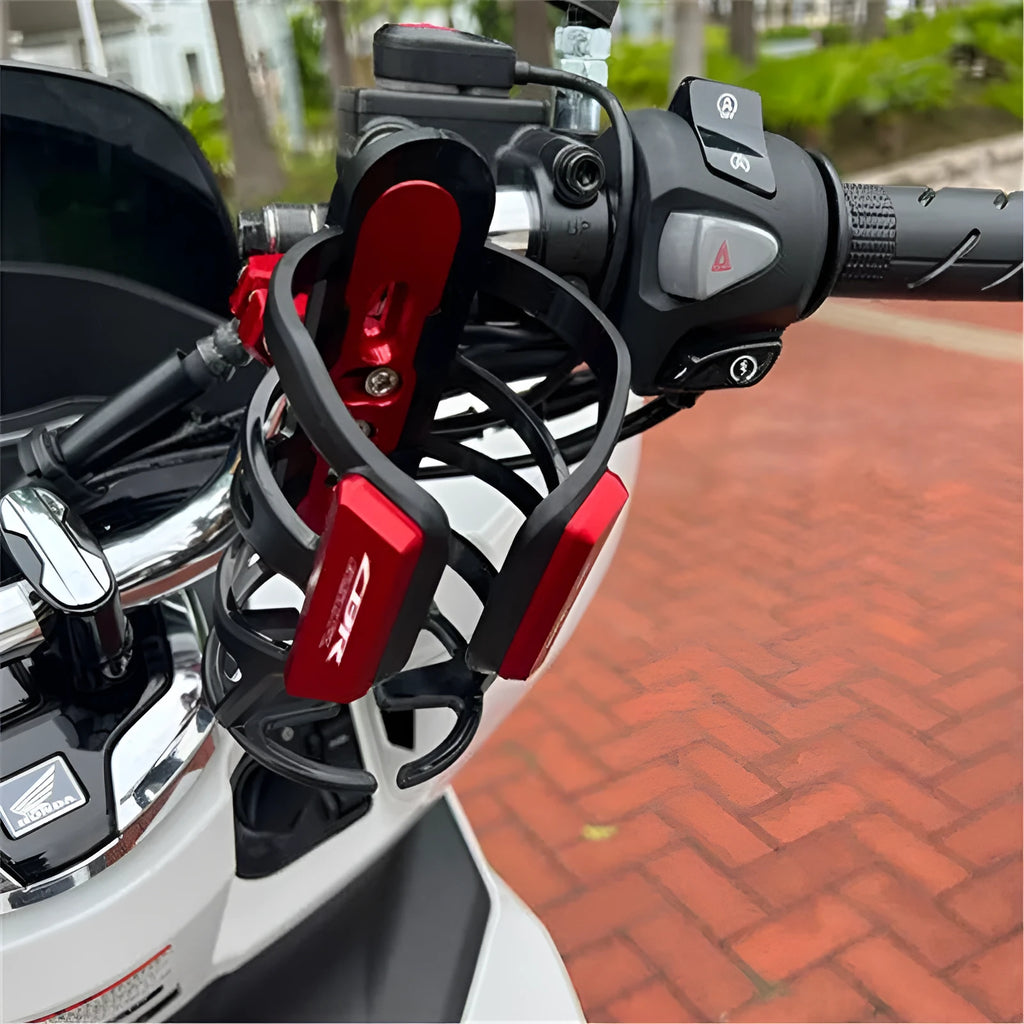 Black water bottle cage mounted on Honda X-ADV scooter bumper