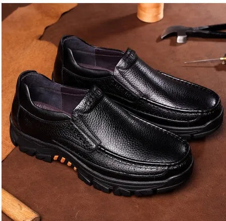 A pair of black and brown business casual leather shoes with a rubber sole, shown from the side.
