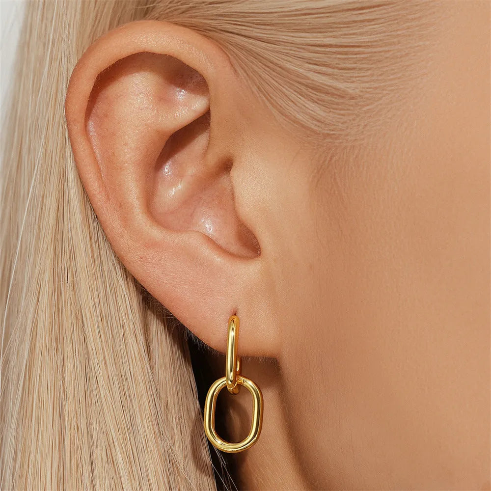 A pair of simple round geometric brass earclip earrings with a gold electroplated finish.