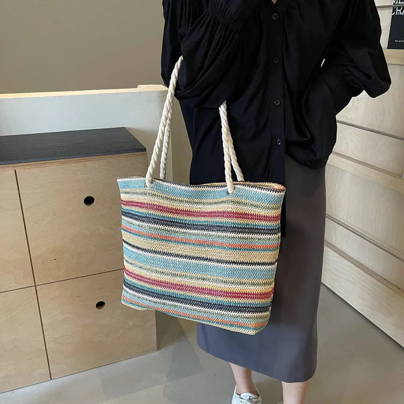 Blue nylon woven shoulder bag with large capacity and polyester lining shown against a neutral background
