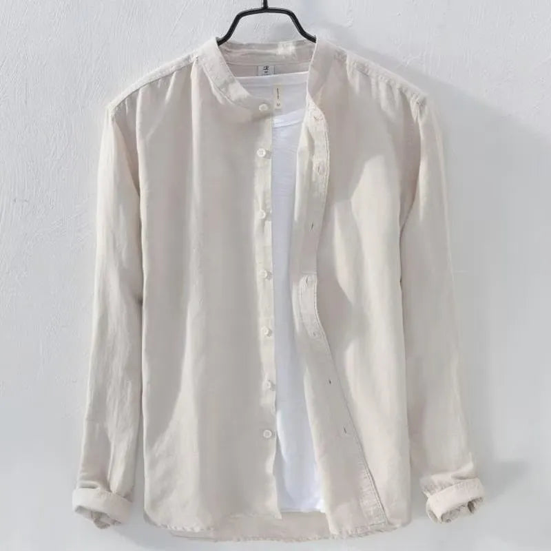 Man's loose fitting long sleeve linen shirt in a solid colour on a hanger.