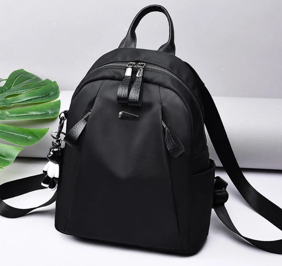 Medium Oxford cloth rucksack in wine red colour showing internal compartments and shoulder straps