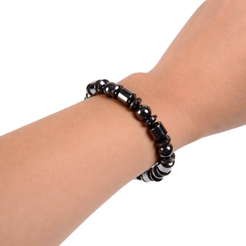 Black pentagram design magnetic therapy bracelet with magnetite and hematite stones on a stretch band.