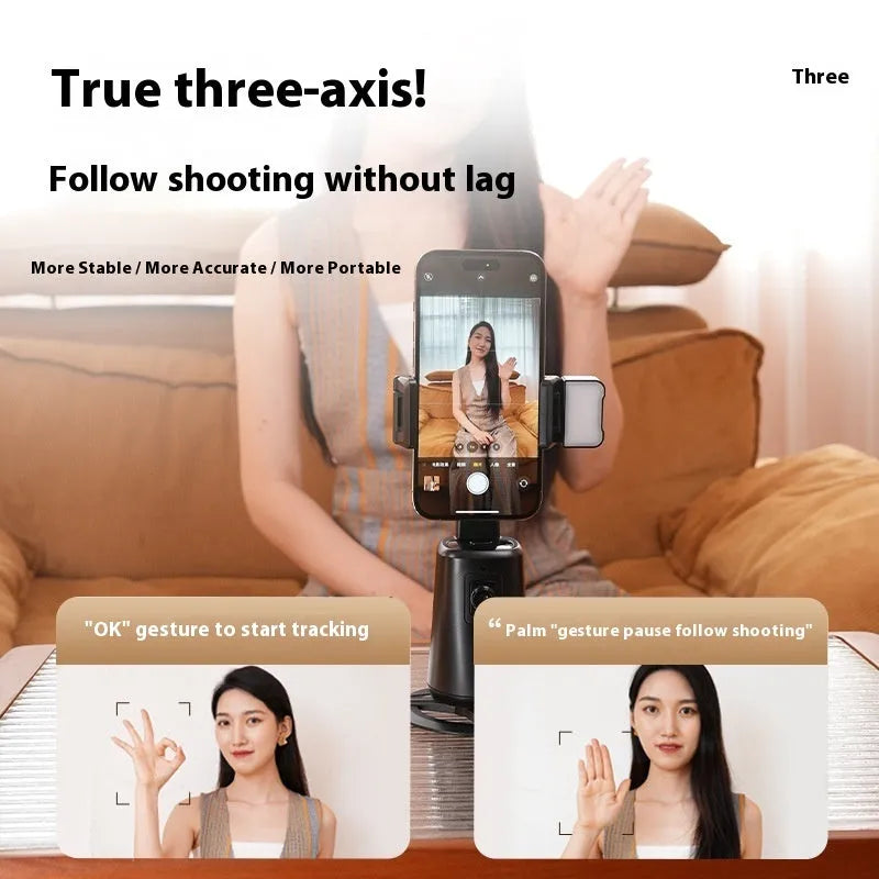 Black intelligent face tracking mobile phone holder with rotating camera head and ribbon lighting on desktop