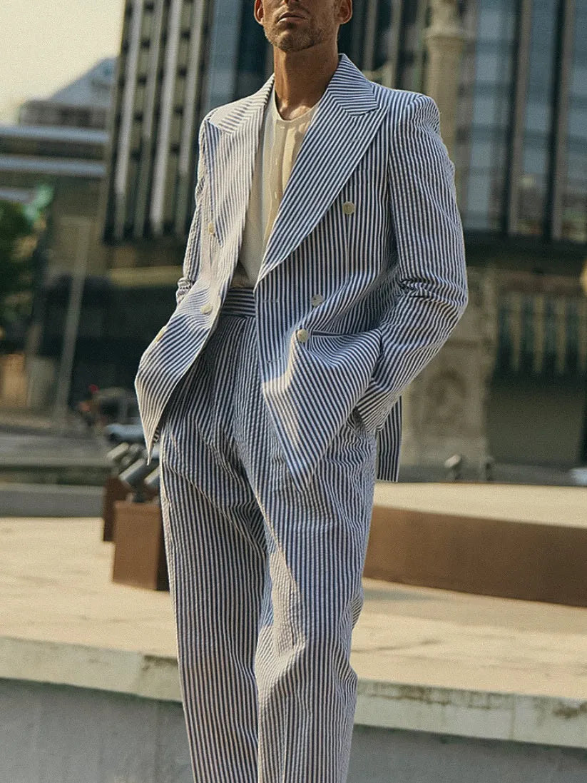Men's blue and white striped polyester suit set with regular fit blazer and trousers on a hanger.
