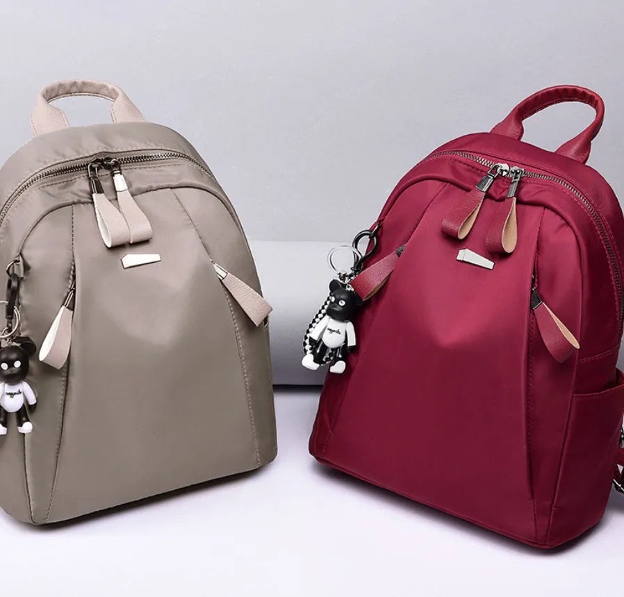 Medium Oxford cloth rucksack in wine red colour showing internal compartments and shoulder straps