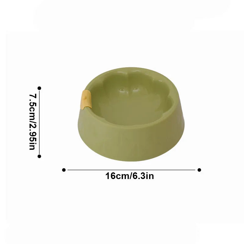 Green plastic double pet bowl with flower-shaped base for cat or small dog food and water.