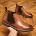 Men's black formal leather ankle boots with pointed toe and square heel on white background