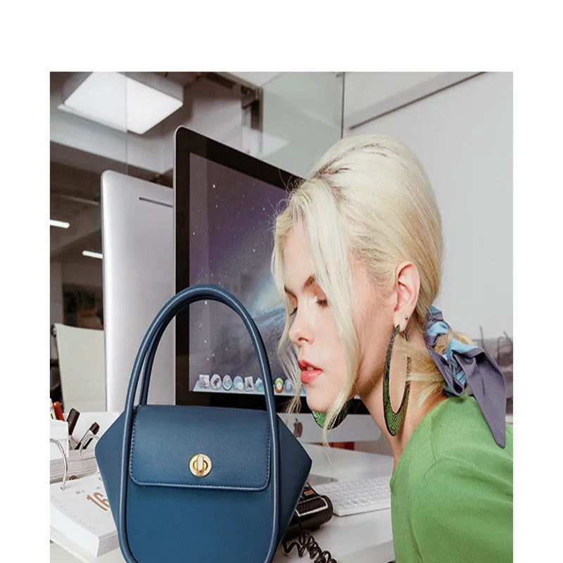 Women's leather cross-body wing bag with buckle closure in four colour options