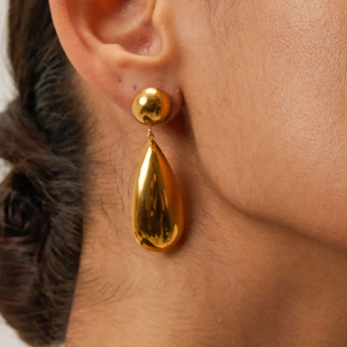 Gold electroplated stainless steel earrings with geometric water drop pendant and hemisphere design