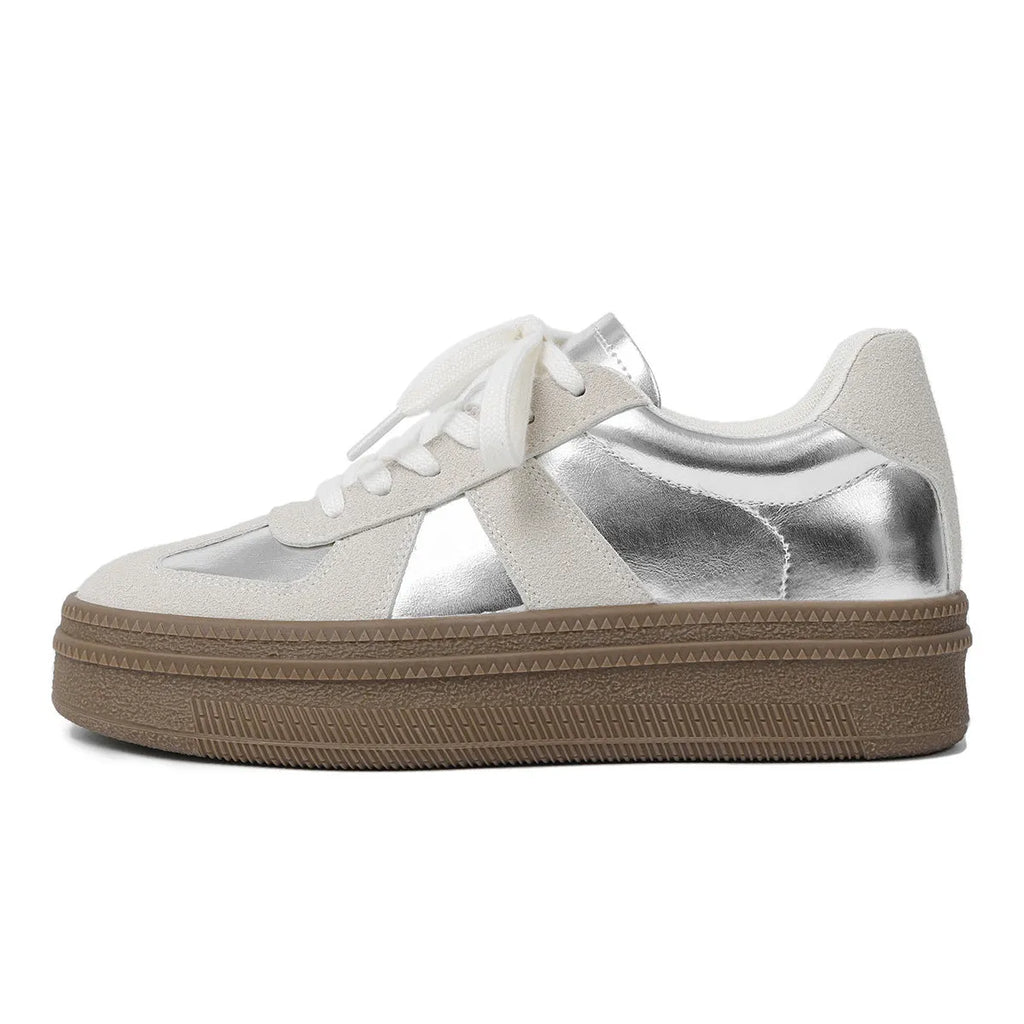 Retro-style silver board shoes with cross straps and round toe on a rubber sole.