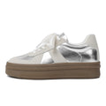 Retro-style silver board shoes with cross straps and round toe on a rubber sole.