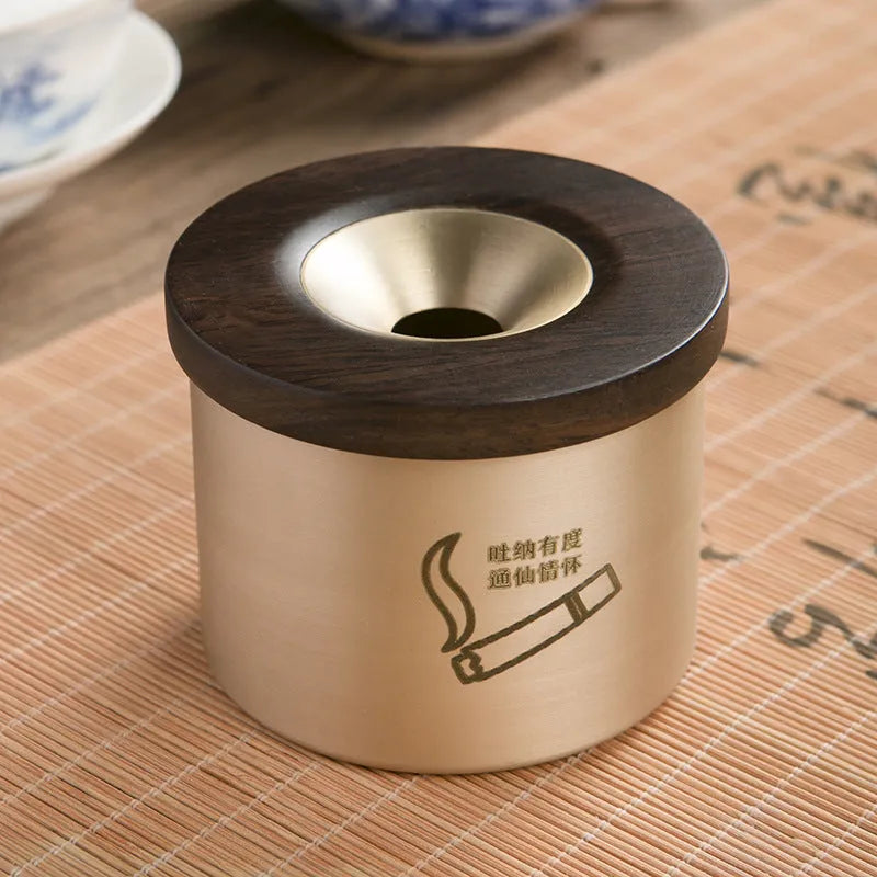 Brass ashtray with wooden lid featuring centre hole design