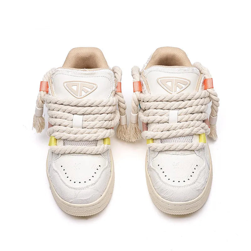 Creamy white old damage lace-up retro skateboard shoes with low-top round toe and platform sole.
