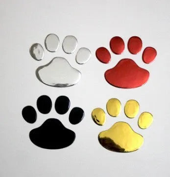 Pair of hand-shaped brush stroke car stickers with dog footprint details on a vehicle bumper.