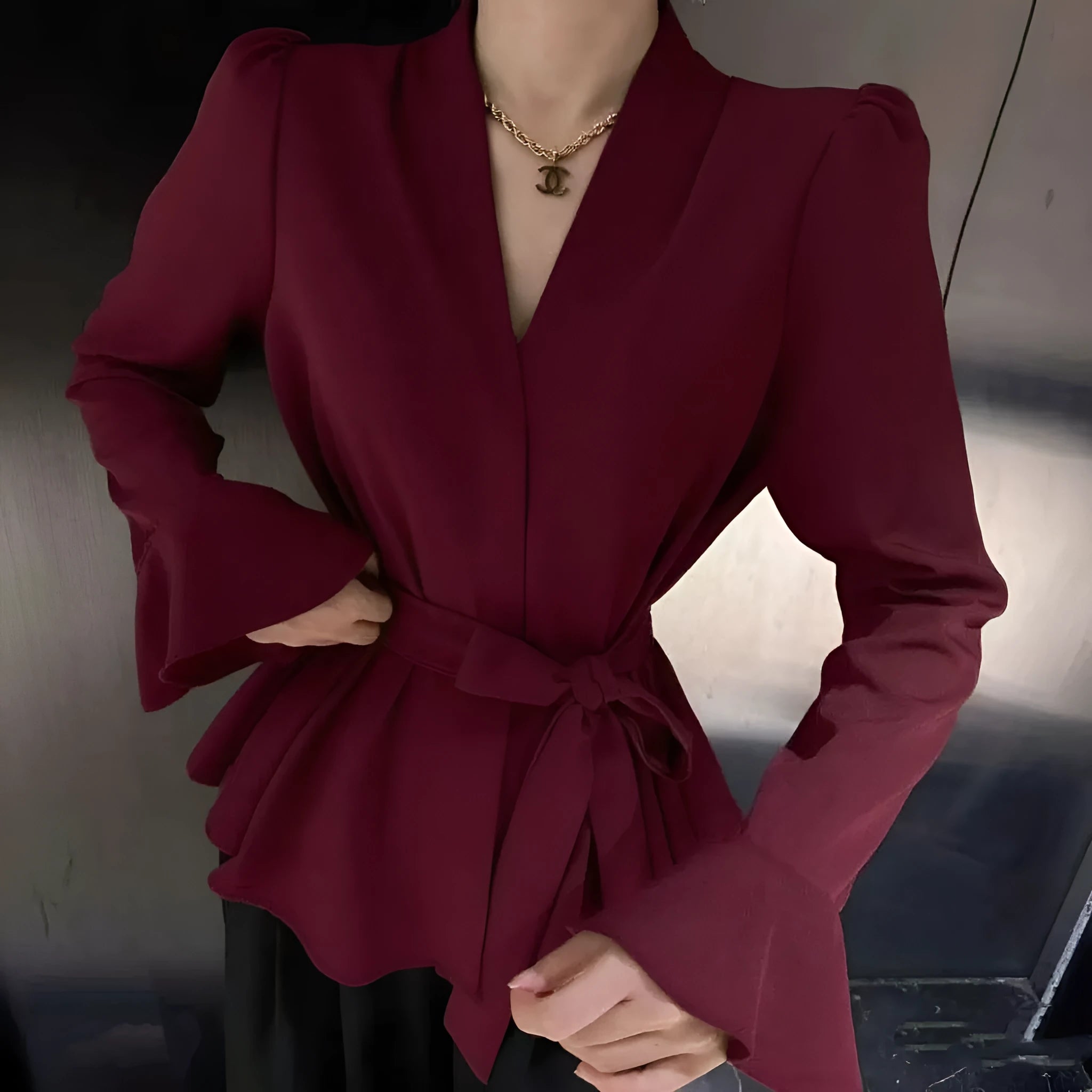 Women's black French-style shirt with irregular collar and long bell sleeves tied at waist