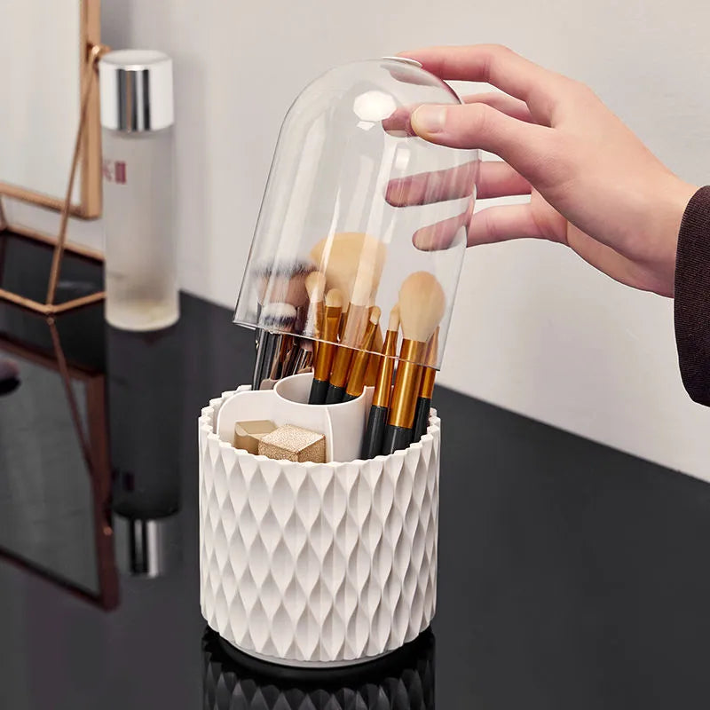 White transparent acrylic makeup brush holder with lid on a desktop, showing rotating base.