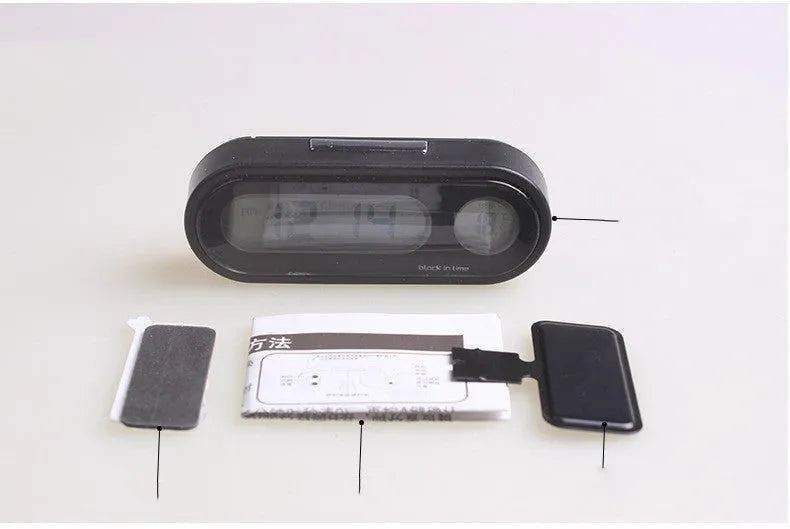 Black electronic car clock thermometer with digital LED display showing time and temperature, featuring an adjustable base.