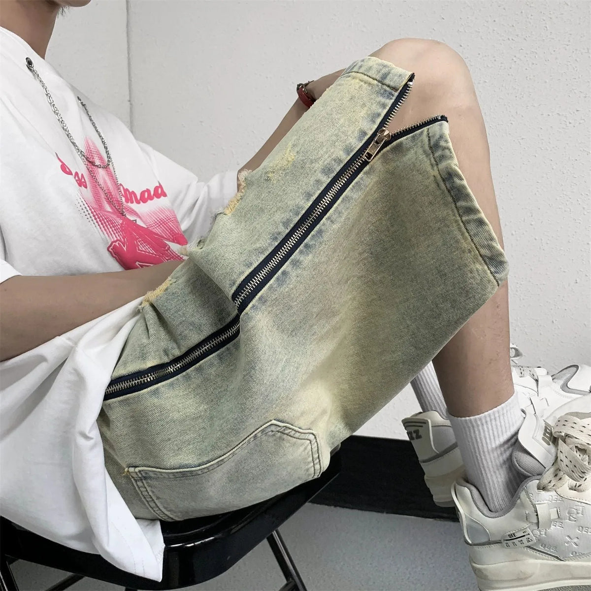 Men's blue retro denim shorts with yellow mud wash finish and ripped detailing