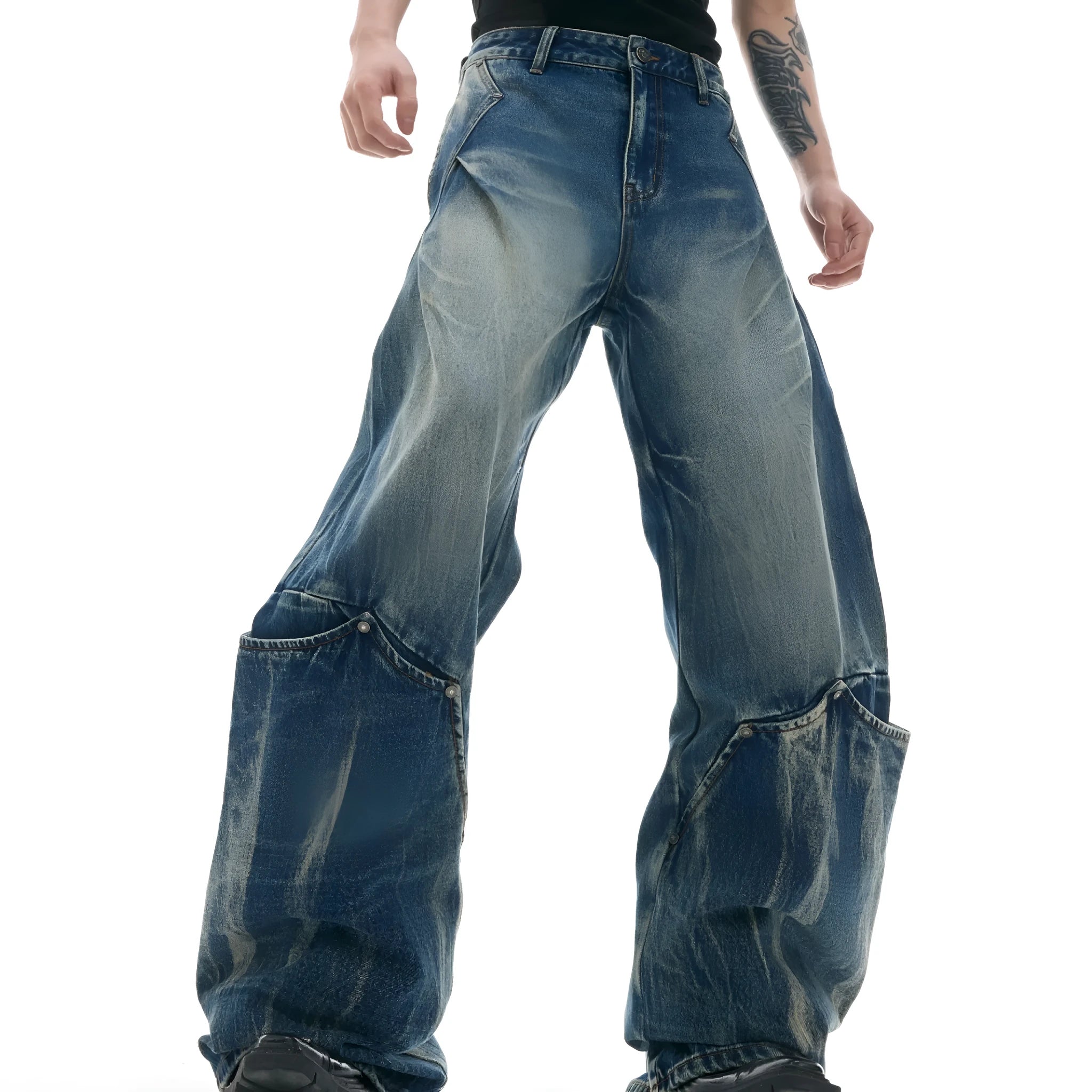 Man wearing verdant blue retro washed burst pattern jeans with a curved knife cut and loose fit.