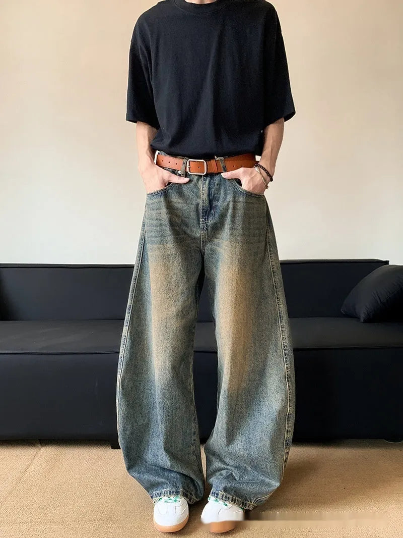 Men's retro blue distressed denim wide-leg trousers showing distressed detailing and wide-leg silhouette