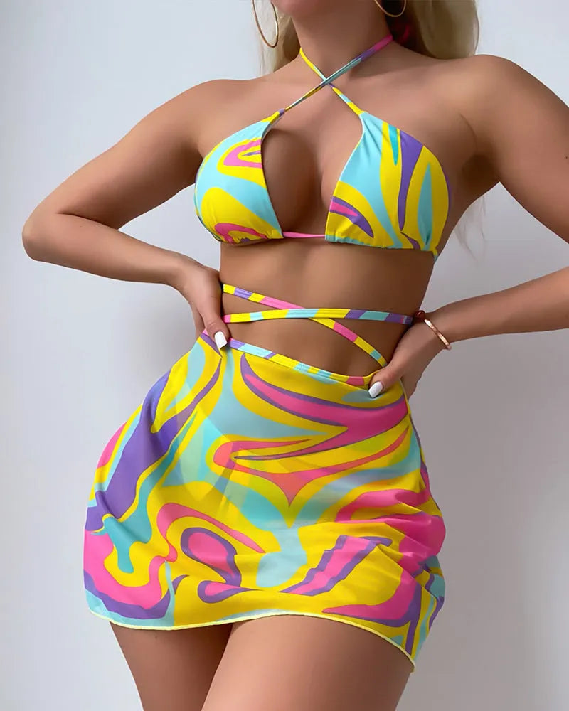 Yellow striped halter lace-up swimsuit for women with matching skirt and shorts.
