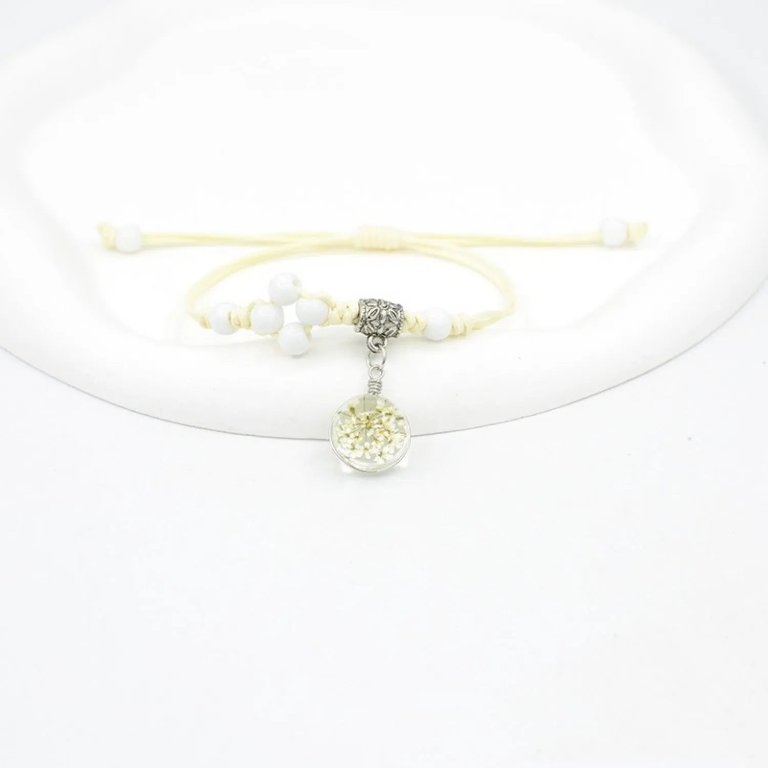 Women's hand-woven glass bracelet with large 1.4cm beads containing dried flowers, shown in blue colour option