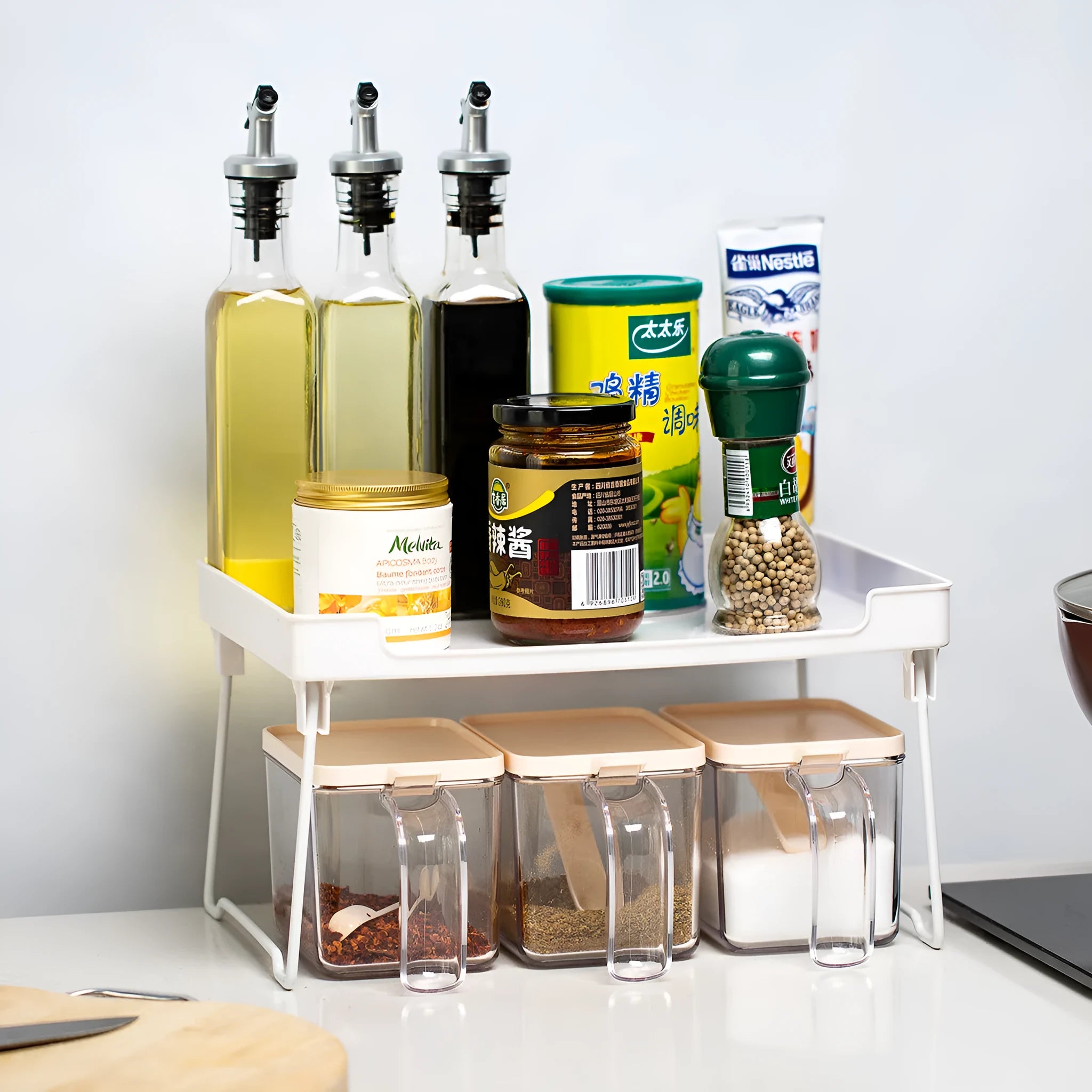 White and transparent plastic kitchen shelf organiser for countertop or cupboard storage.