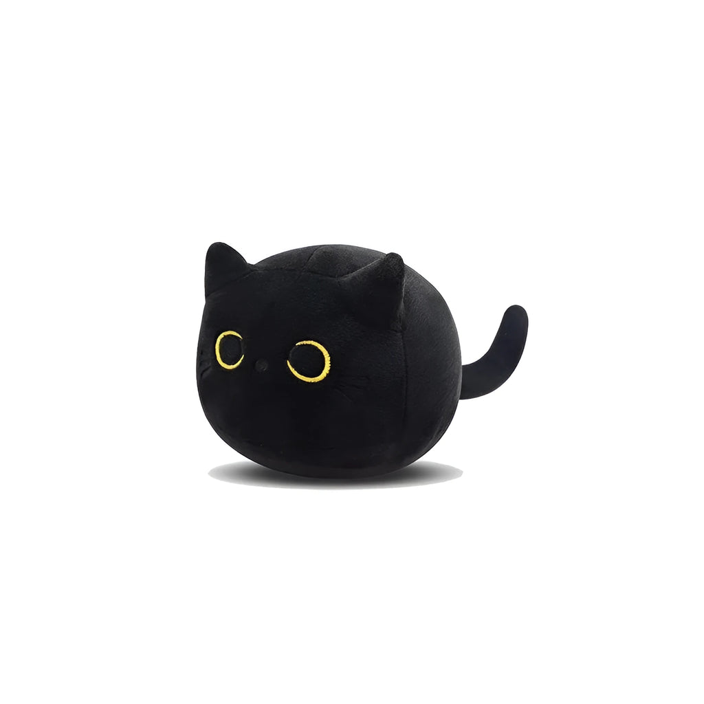 Black fluffy cat plush toy stuffed animal on a sofa, used as a soft cushion.