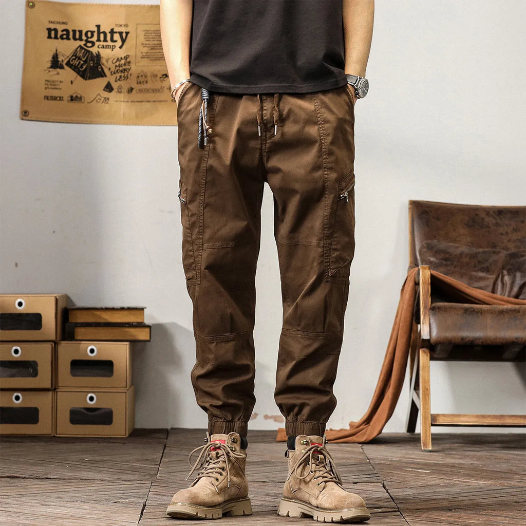 Men's khaki cotton harem pants with tapered ankle band and zip placket front view