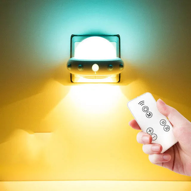 Remote control UFO shaped bedside night light in blue, pink, or white colour options.