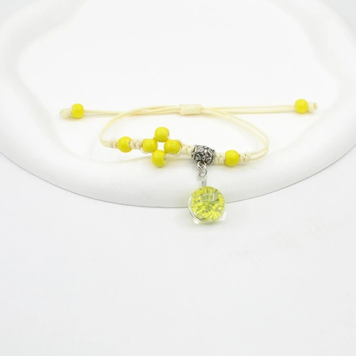 Women's hand-woven glass bracelet with large 1.4cm beads containing dried flowers, shown in blue colour option
