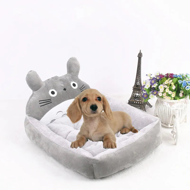 Blue cartoon-style pet bed sofa for a small dog, showing soft plush interior.