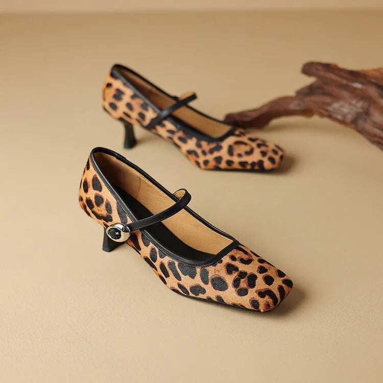 Women's black square toe ankle-strap stiletto heels with horse hair upper on wooden surface