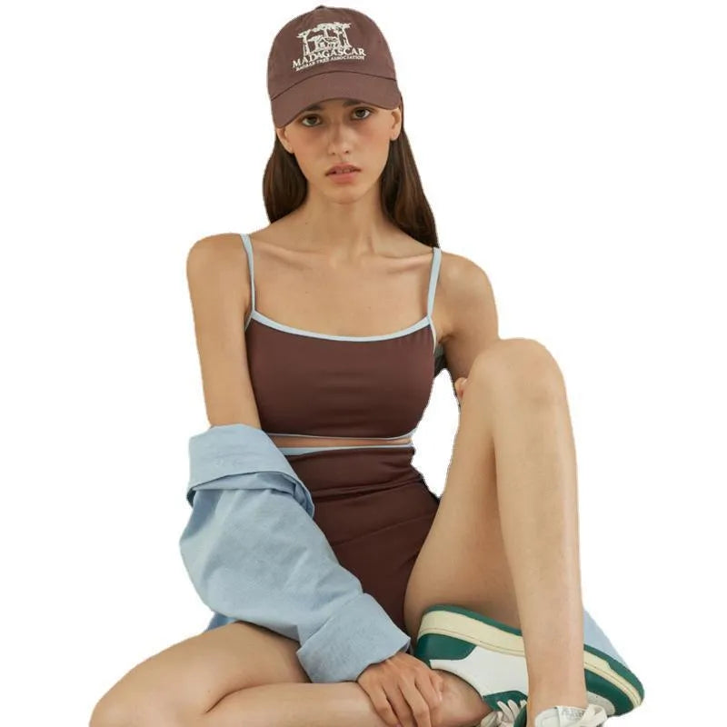 Brown women's triangle one-piece swimsuit on a hanger.