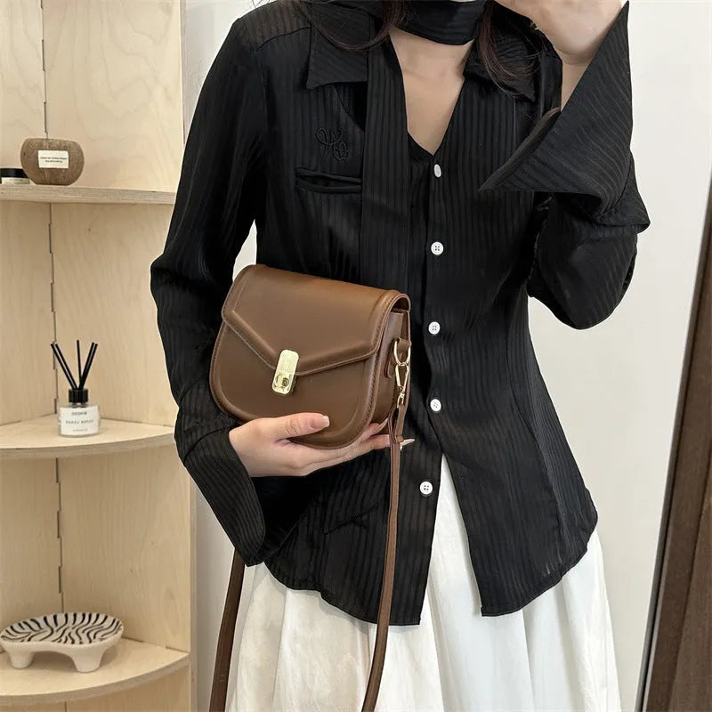 Soft textured PU leather messenger bag with clamshell opening in dark brown colour