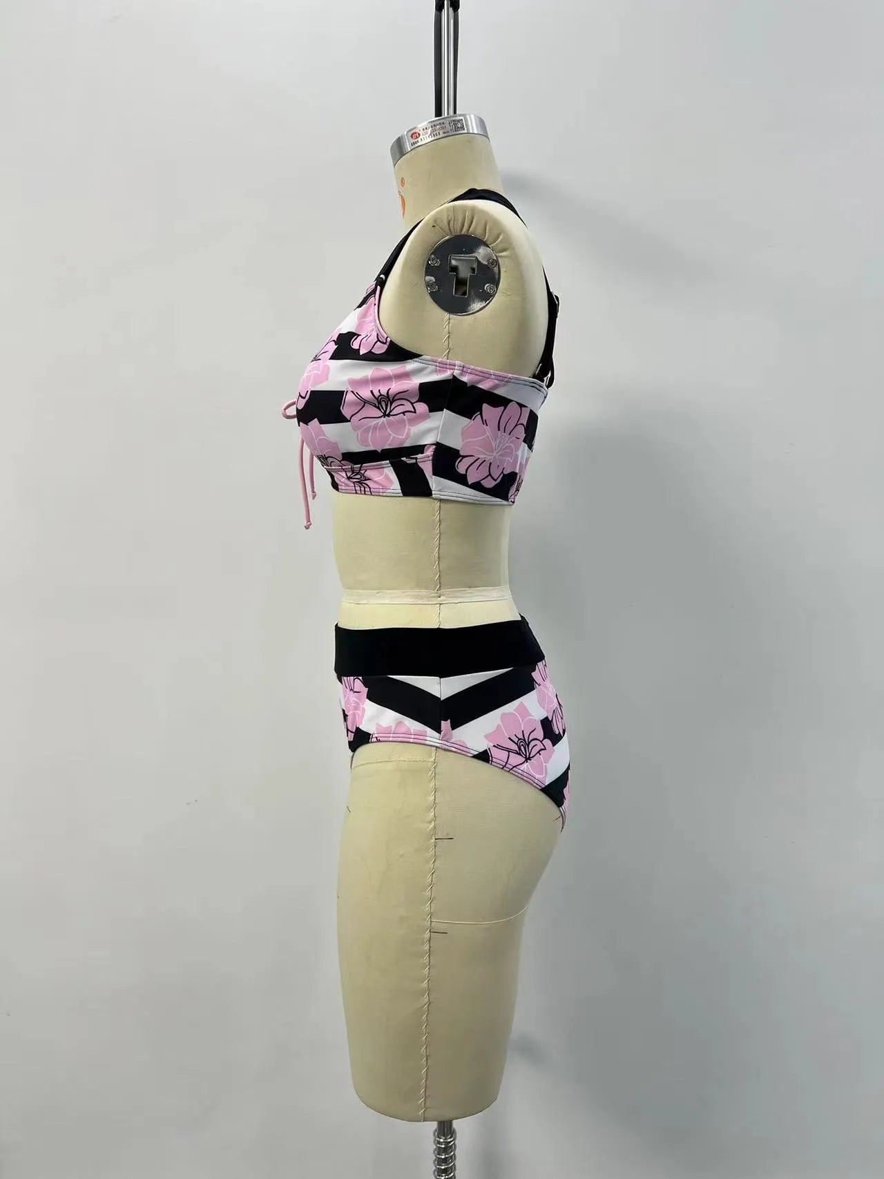 Black women's bikini with printed belly coverage and slimming split leg design.