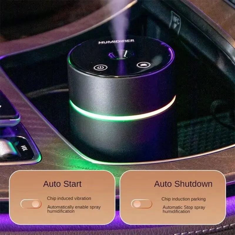 Black aluminium car humidifier and essential oil diffuser with night light on a desk.