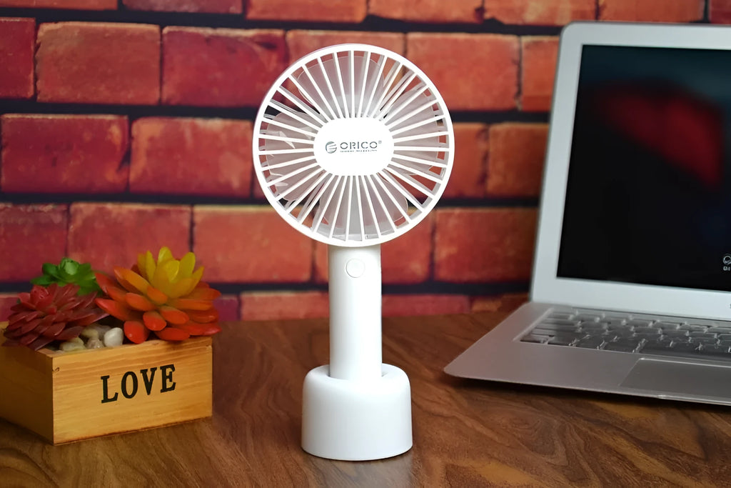 White ORICO FH1 portable USB rechargeable desk fan with three speed buttons and a compact design.