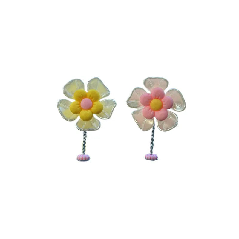 Small colourful plastic swing car decoration in blue, green, pink, purple, and yellow options.