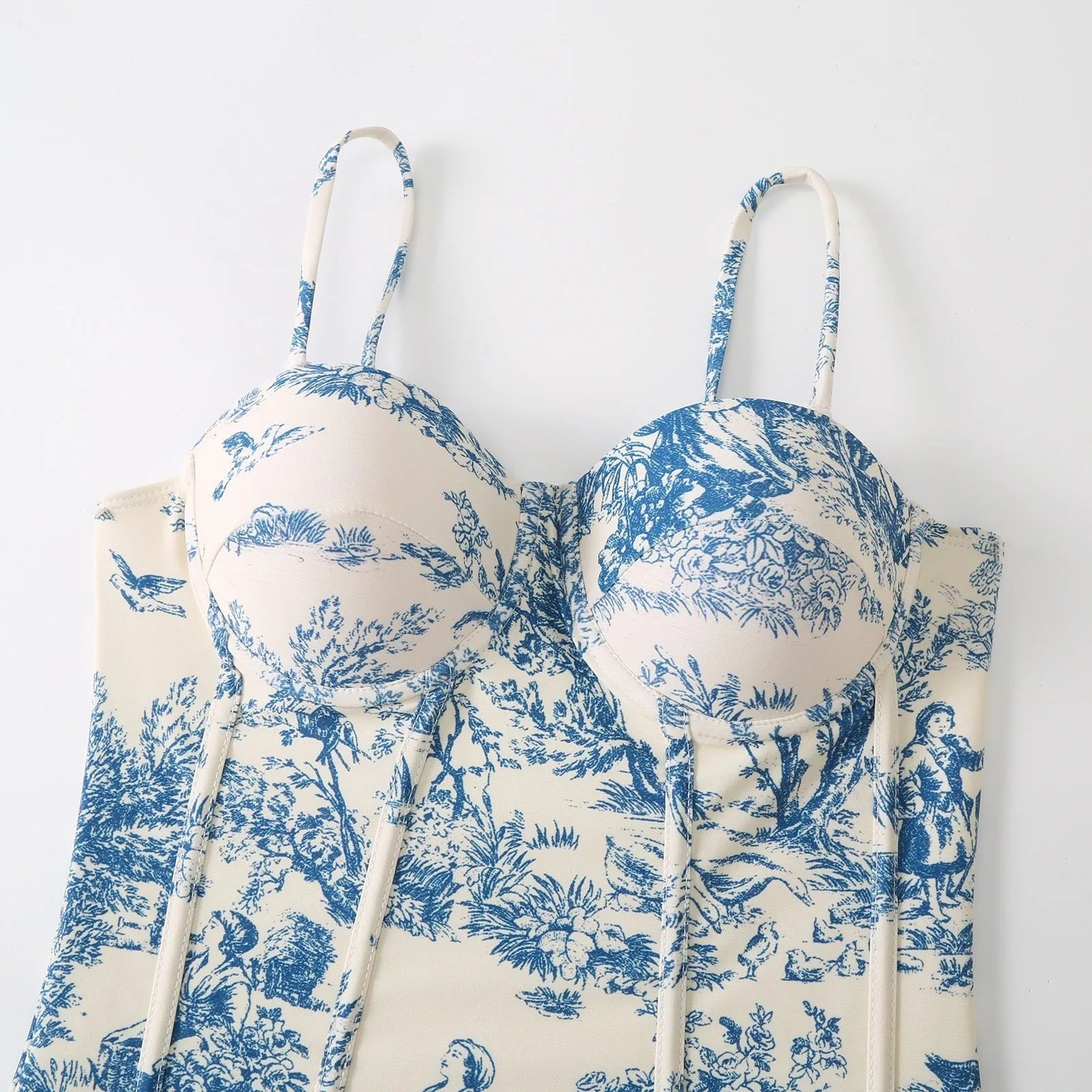 Women's patterned blue one-piece swimsuit with matching gauze skirt accessory