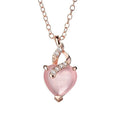 Women's rose gold necklace with a heart-shaped pink crystal pendant on a cross chain.