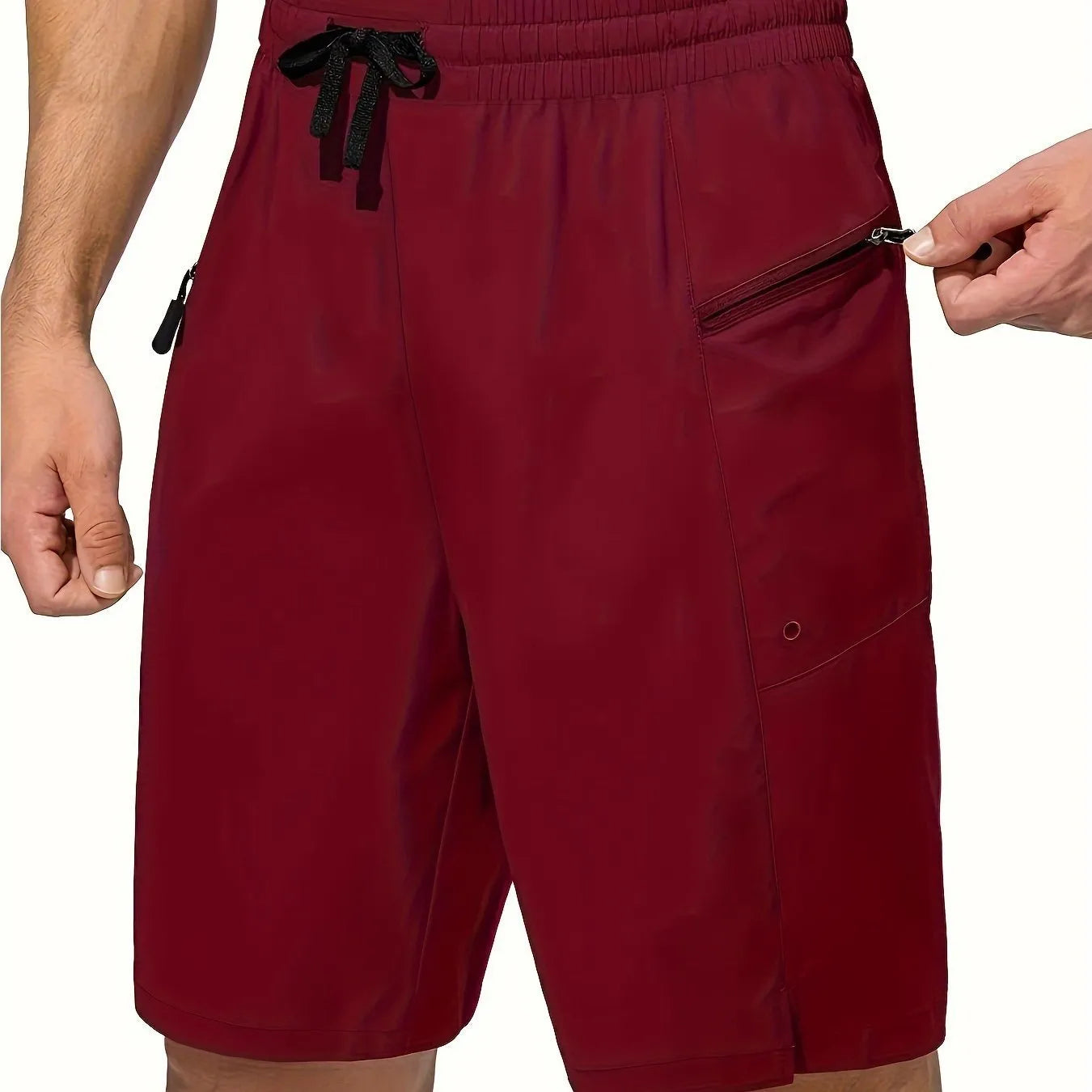Man wearing solid colour quick-dry polyester beach shorts in a straight-leg style by the water.