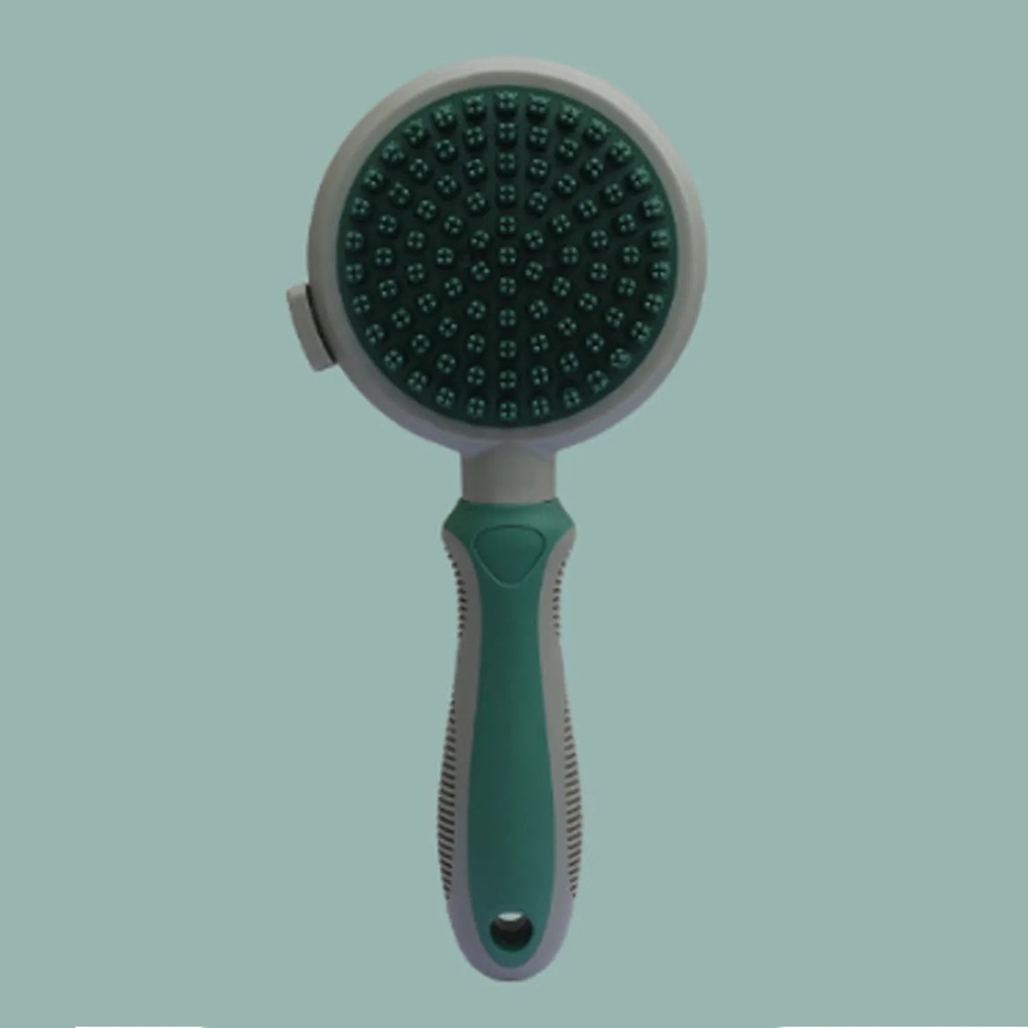 Pink and green double-sided cat brush with release button next to a flea comb.