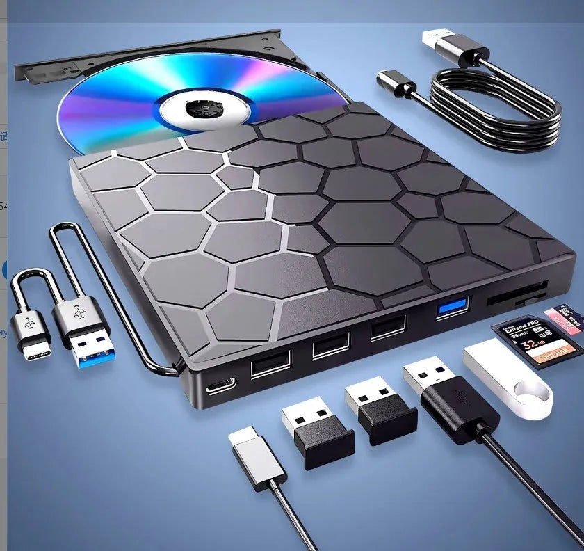 Black external USB CD/DVD drive on a desk next to a laptop