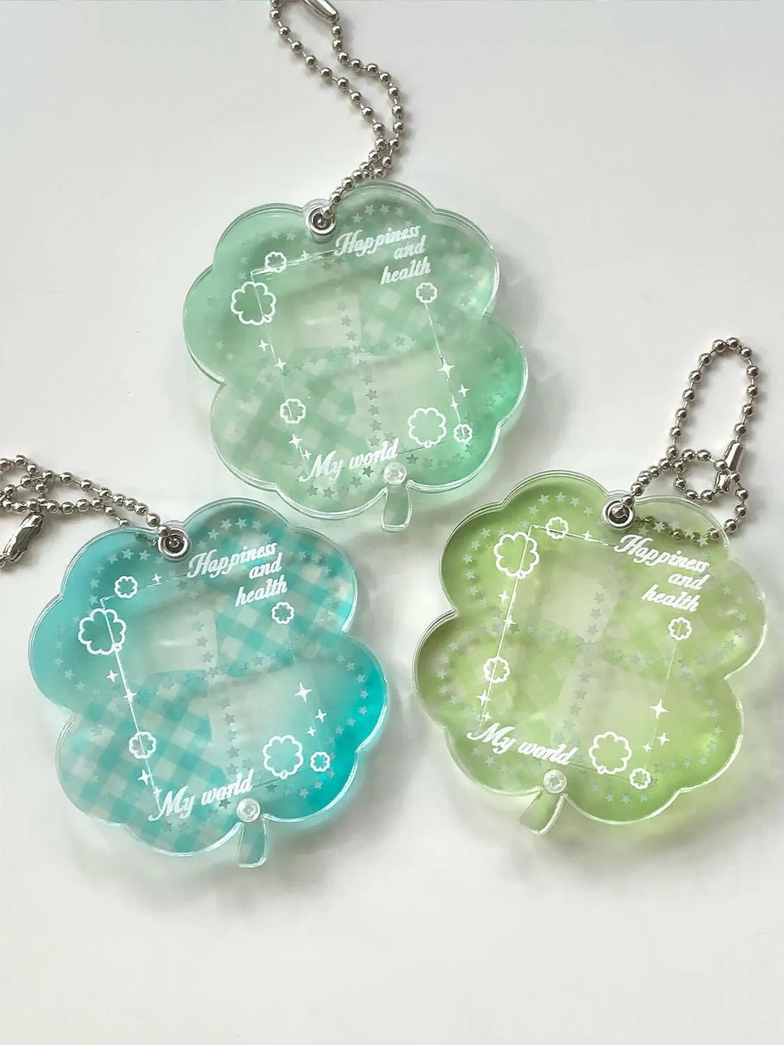 Acrylic four-leaf clover phone pendant in three colour variations