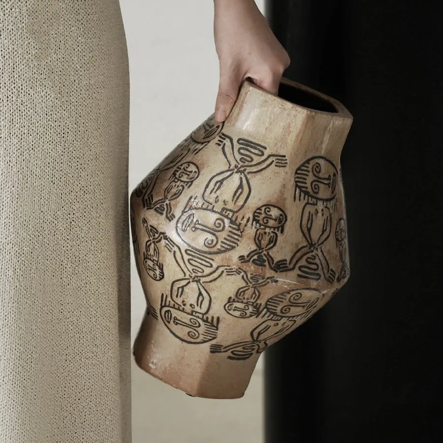 Hand-painted ceramic vase with tribal totem patterns in cylindrical shape